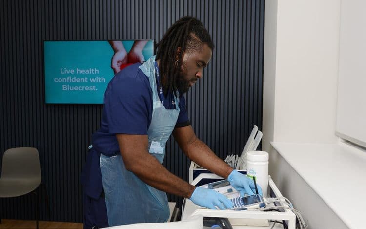 Bluecrest employee working at a machine.
