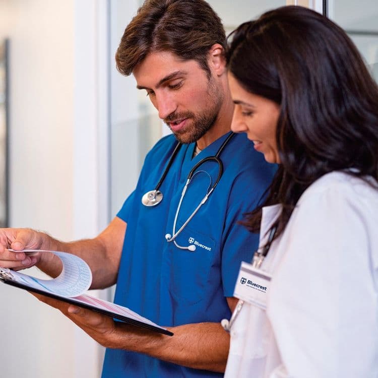 Doctor reading a Bluecrest Wellness health check report